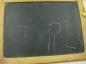 Trey Hrabarchuk used the chalk and slate to print his name as a student