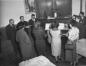 A group of people sing around a piano at St. Francis de Sales church