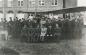 Air Cadets, Band, and Officers seated in front of a bi-plane near the Town Hall