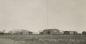 View of High River Airport hanger, radio tower, and other buildings.