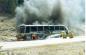 A Brewster tour bus on fire on the side of the highway coming into Jasper townsite.