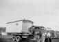 The Kenyon's oil town house being moved on the back of a truck