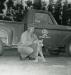 Leo Brisson kneels by his truck while displaying a lynx he trapped on the Ohio Oil Company lease.