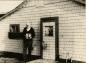 Aubrey Kerr stands beside the chicken coop offices used by Imperial at the beginning of the oil boom