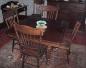 A table and four chairs located in the dining room