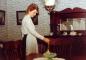 Pam Fowlow dusting the table in the dining room