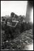 Peter Collins and Henry Lambert loading the ore car. Spectator to the far left is John Slaney