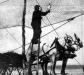 Local fisherman climbing a ladder to retrieve the fish off the nets.