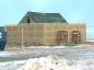 The sidewalls of the protective barn are set up around the Doucet House. 