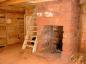 A view in the kitchen:  The fireplace in proximity to the front door on the left.