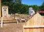 The foreman (Selwyn Buote) building the well house.  Note the outhouse to the far left.