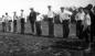 Men and boys sack race at a picnic