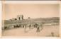 Pioneers and their children  skate and play hockey on the river.