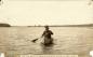 An Aboriginal man paddling a canoe on the Saskatchewan River.