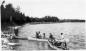 Same men as previous photograph with three canoes below Demicharge Rapids on the Saskatchewan River.