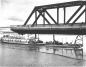 David N. Winton and barge travel through open span of the railway bridge.