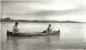 Robert Tobacco and Doug Durking paddling a canoe on the Saskatchewan River.