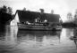 Gillnetter in Farmyard in Front of Horse Barn during the Fraser River 1948 Flood