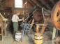 John Millar grinding corn with the Barford-Perkins grinder