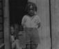 Bertha, at the age of 5, standing in a doorway of an unknown building in 1916. 