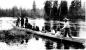 First Nations people traveling by dugout canoe on the Parsnip River in the late 1890s. 