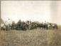 Men working in fields with a steam thresher.