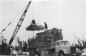 Loading logs onto truck for transport to mill.