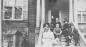 Homer Watson (middle, front row) with his friends and family, on front steps of house