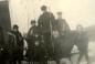 A group of lads pose with their sticks before strapping on the blades for a game of shinny.