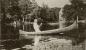 R.Tait McKenzie paddles his birch bark canoe on the mill pond formed by the Indian River.