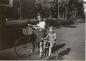 Betty Hinton riding her first bicycle with her brother Bob.