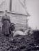 Ukrainian immigrant family in front of their log house