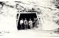 Three men and the Narrow Gauge rail line at the mine entrance in the Dirt Hills. 