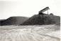 Clark Construction's dump truck depositing clay from the Blue Hills Pit on one of the stock piles.