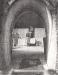 View into Kiln through Parabolic arched Kiln doorway showing men unloading fired brick.