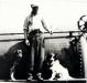 Dan Bednard on Railway fuel car with two dogs, 1937