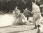 Umpire Ed Petro gets ready to call Halifax Shipyards runner Lou Bourbonnais out at home plate