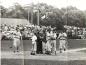 Members of the Halifax Cardinals cross and gather at home plate after home run.