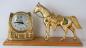 Gold horse and horseshoe with electric clock on wood base, Snider Clock Corporation.