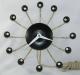 The black version of the Snider Spider electric wall clock, model 500, Snider Clock Mfg Co.