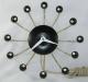 The black version of the Snider Spider electric wall clock, model 500, Snider Clock Mfg Co.