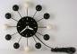 A black and white version of the painted-wood "atomic" electric wall clock, Snider Clock Mfg Co.
