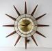 An electric starburst wall clock with short walnut cones, Snider Clock Mfg Co.
