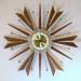 Alternating wooden cones and Vs starburst electric clock, Snider Clock Mfg Co.
