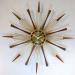 Wood cones and spindles, starburst electric wall clock, Snider Clock Mfg Co.