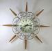 A fancy metal-rod loops starburst wall clock, battery movement, Snider Clock Mfg Co.