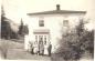 Members of the Green Family posing in front of the family home in Trinity.