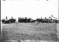 View of a threshing team in a field