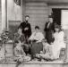 Aberdeen family sitting on the front porch of their house at the Coldstream Ranch