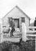 William Pugh, in front of his fish shop, with one of his herd of sheep